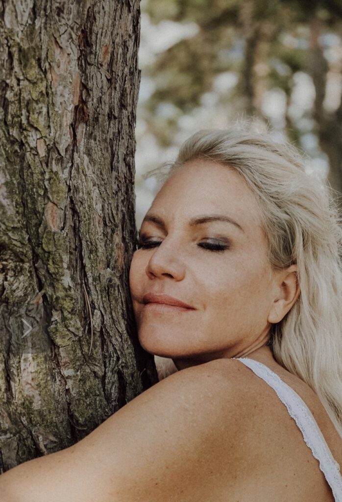 Jennifer Luise, Augen geschlossen, an einen Baum gelehnt